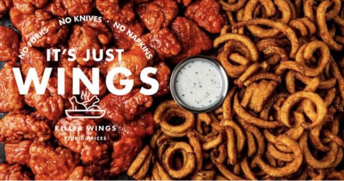 An It's Just Wings promotional graphic showing saucy chicken wings, curly fries, and a cup of ranch dip.